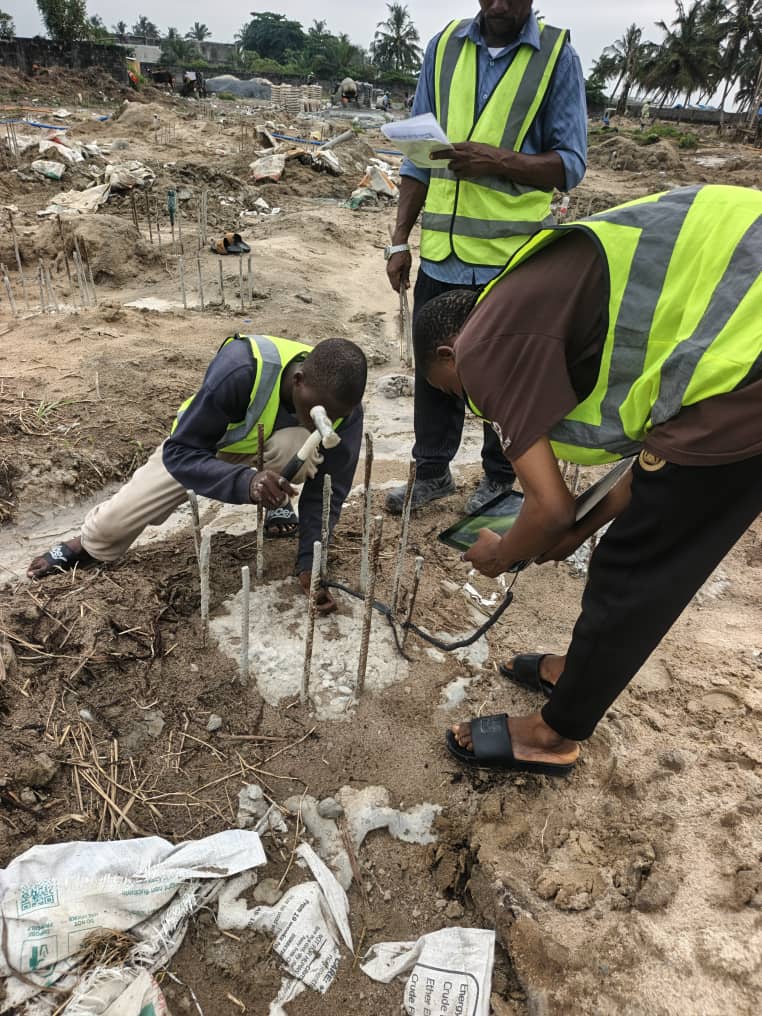 Workers drilling on a muddy site