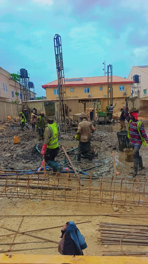 Crew laying out foundations with a piling mast behind