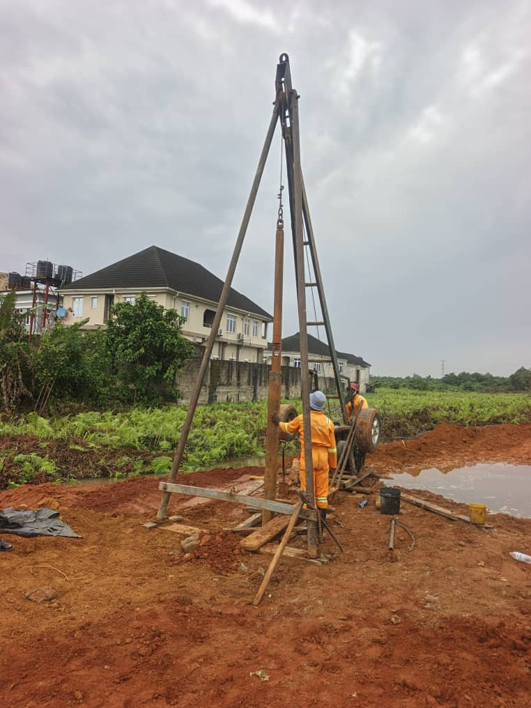 Piling rig on a cleared site against a cloudy sky